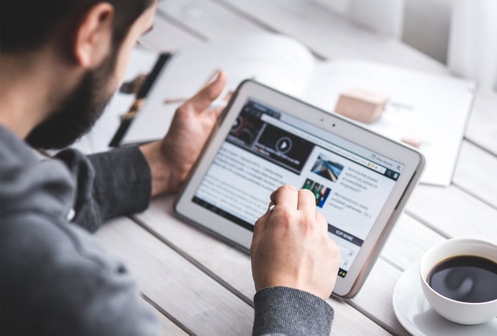 man-reading-on-tablet